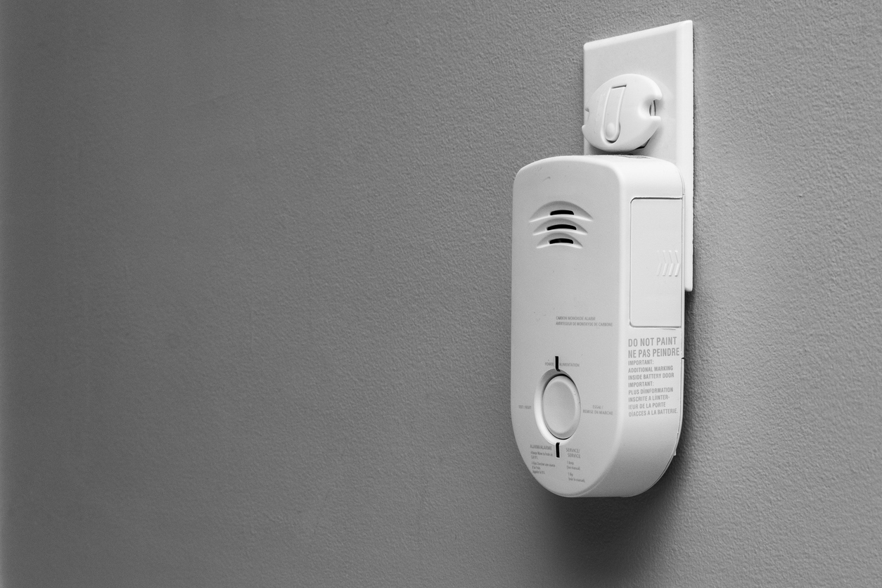 Carbon Monoxide (CO) Monitor Plugged Into The Wall Of A Residential House For Safety.
