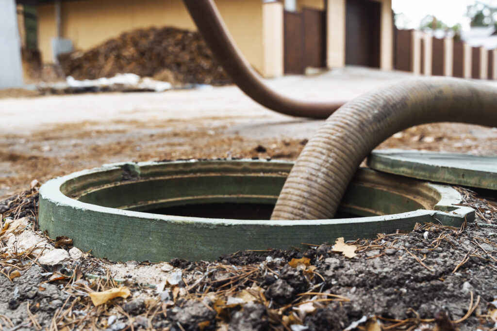 Pipe In The Drainage Pit. Pumping Out Sewage From A Septic Tank. Septic Tank Service