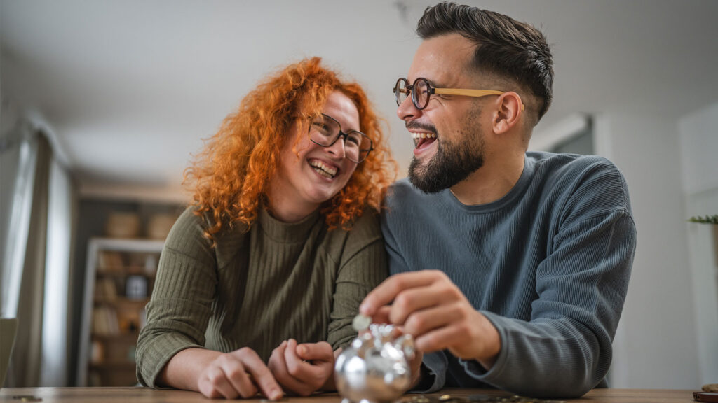 Happy couple saving money